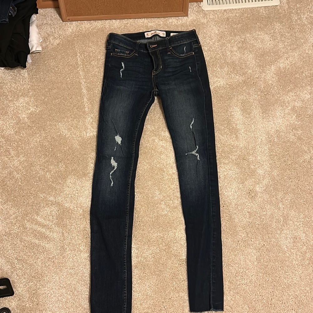 Dark wash jeans with ripped legs